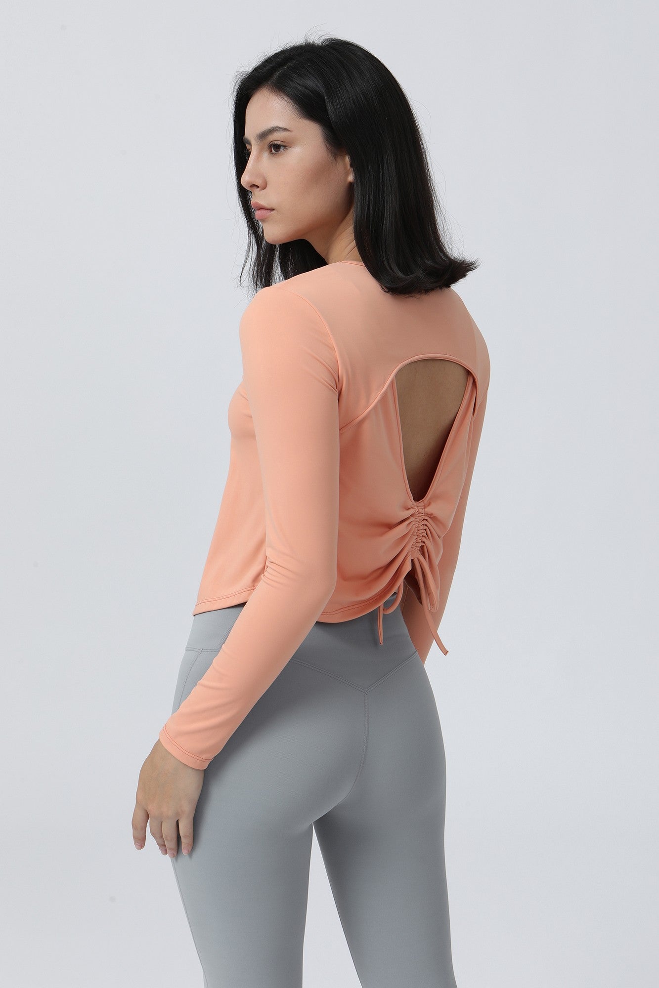 Long Sleeve Ruched Back Cutout Crop Top by bornfocus