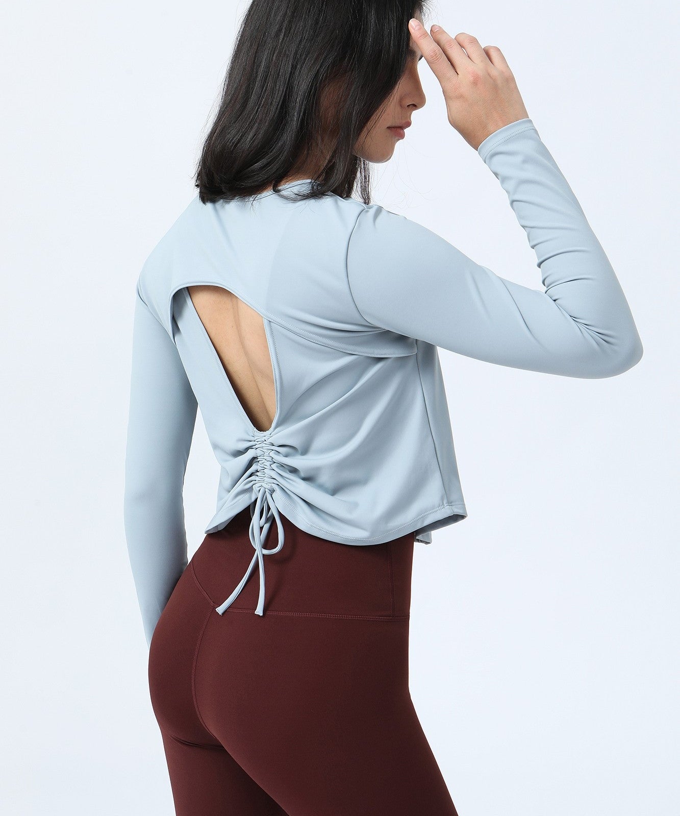 Long Sleeve Ruched Back Cutout Crop Top by bornfocus