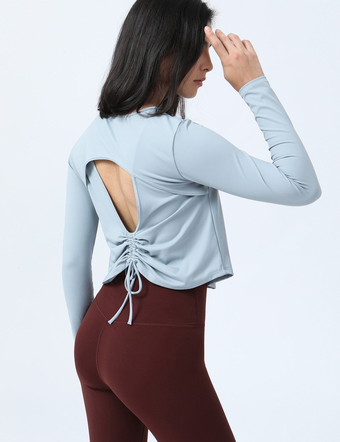 Long Sleeve Ruched Back Cutout Crop Top by bornfocus