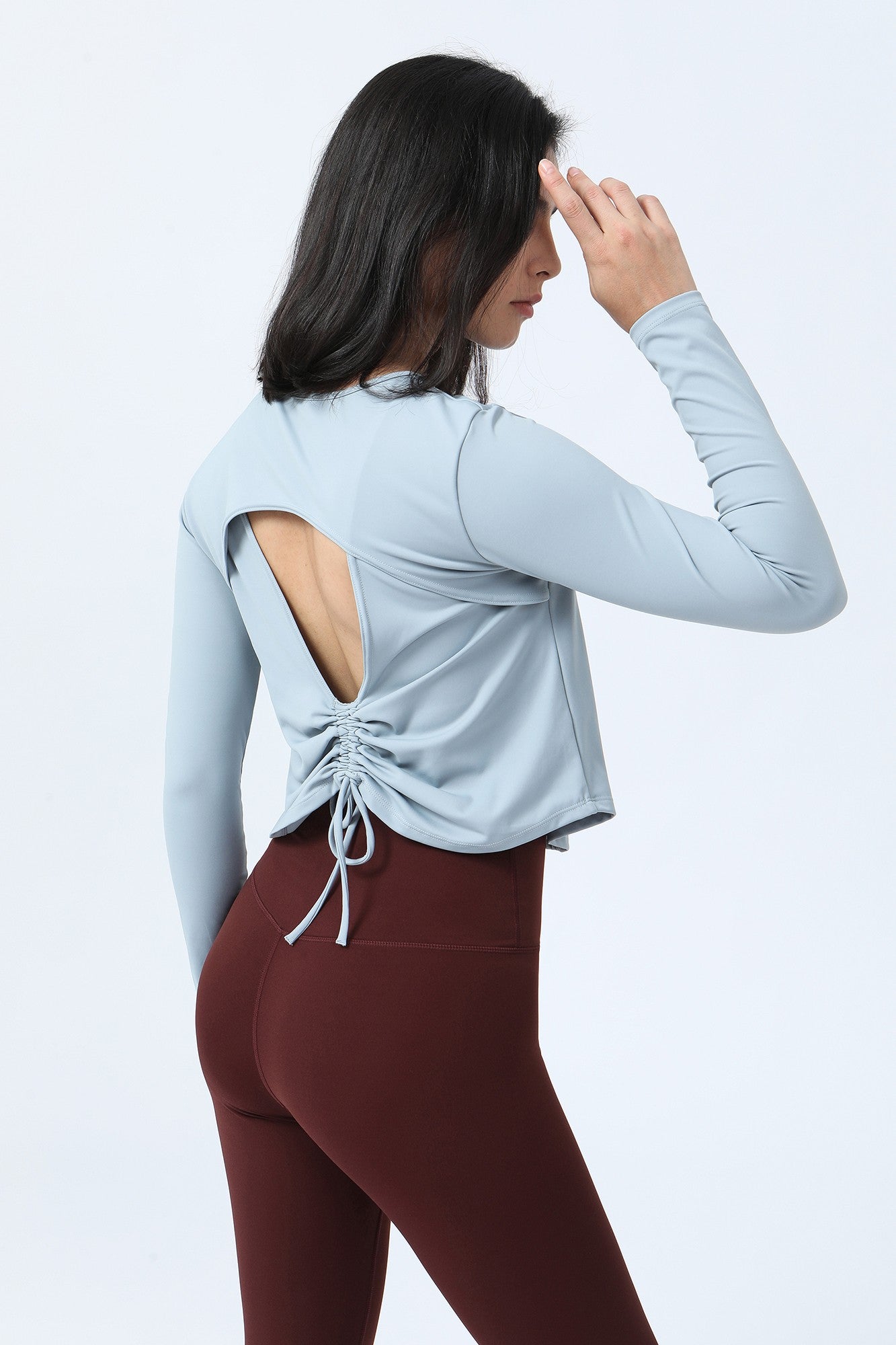 Long Sleeve Ruched Back Cutout Crop Top by bornfocus