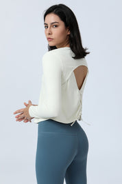 Long Sleeve Ruched Back Cutout Crop Top by bornfocus