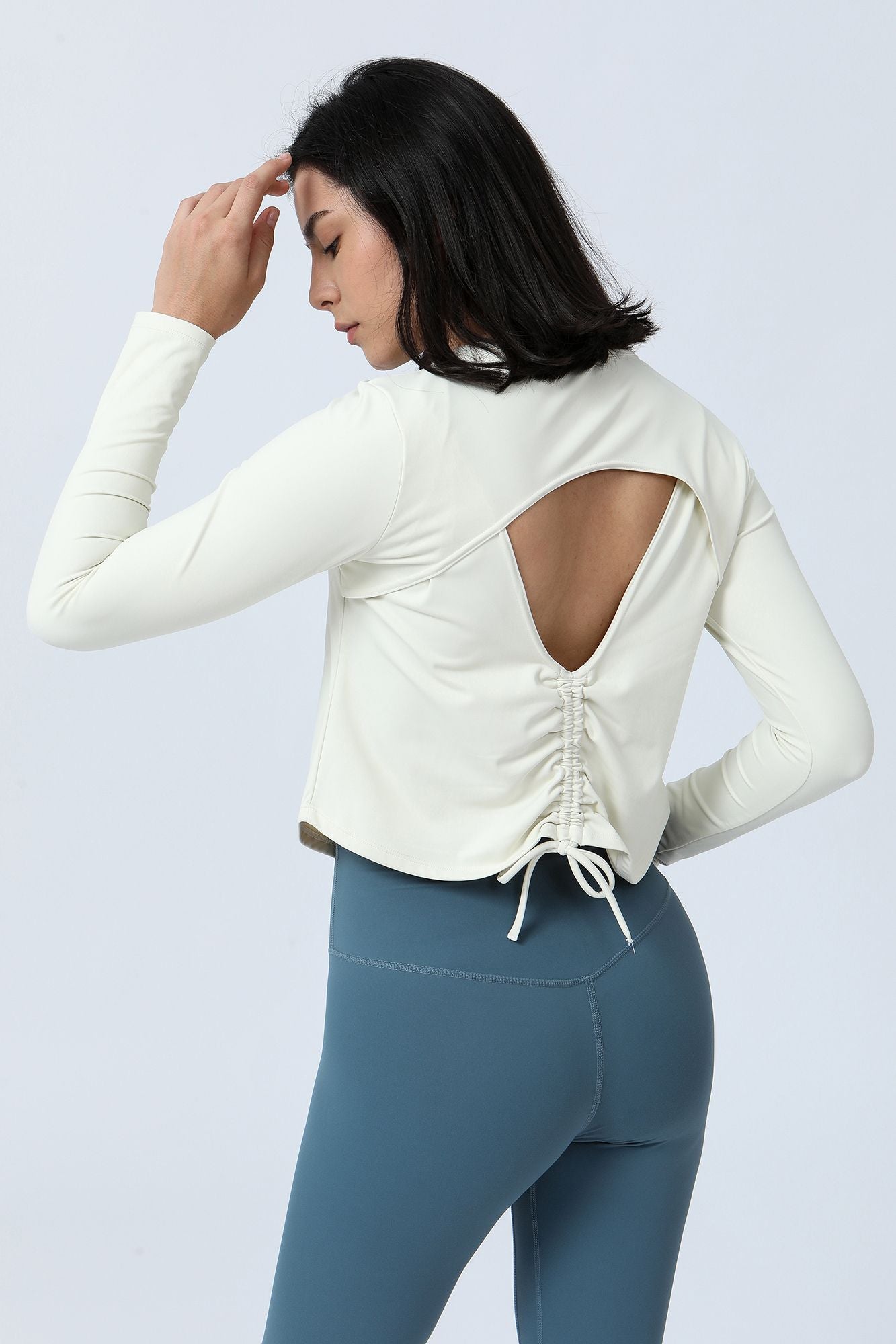 Long Sleeve Ruched Back Cutout Crop Top by bornfocus